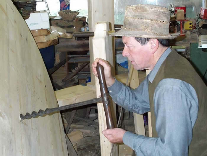 Boring a hole with an auger to take the crankshaft